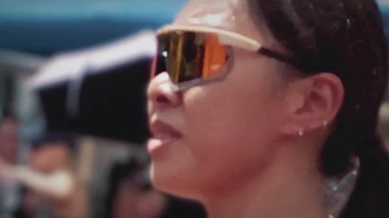 Athlete wearing polarised high contrast orange mirrored lens with cream carbon fiber frame. 